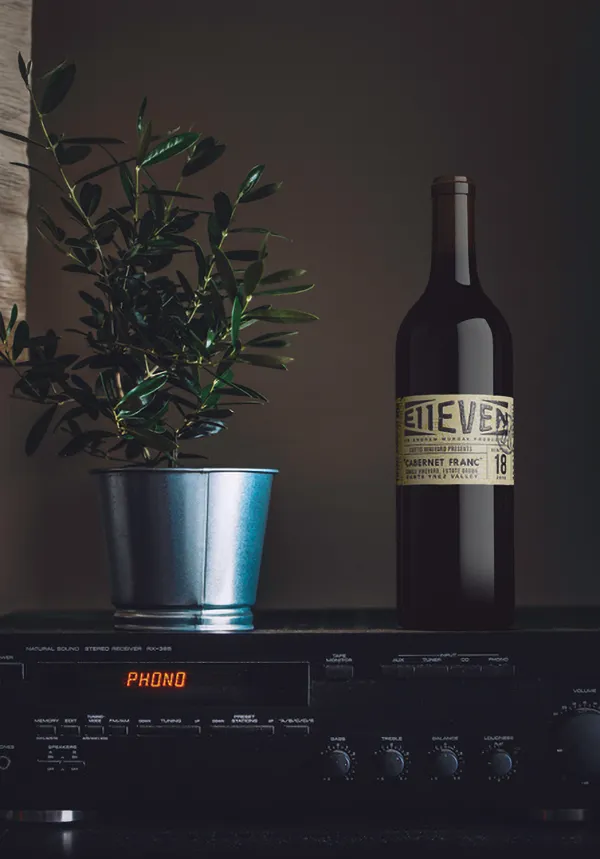 E11even wine bottle on top of a vcr player